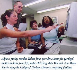Adjunct faculty member Robert Jones provides a lesson for paralegal studies students, from left, Sasha Holtzberg, Rita Vale and Ann Marie Yturbe, using the College at Florham Library’s computing facilities.