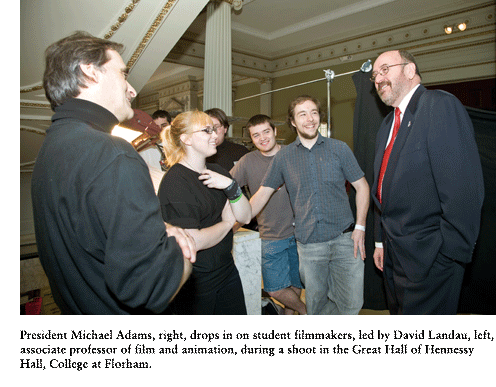 President Michael Adams,  drops in on student filmmakers, led by David Landau, associate professor of film and animation, during a shoot in the Great Hall of Hennessy Hall, College at Florham.