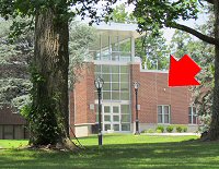 Photo of the Dreyfuss center with a red arrow pointing to the location of the webcam on its exterior