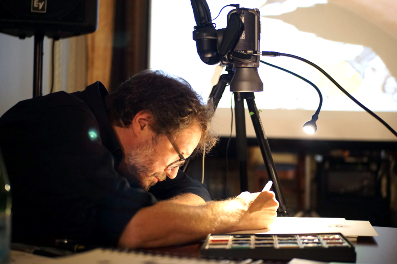 Artist Michael Arthur draws a live depiction of the day’s events. (Photo by Ryan Silva)