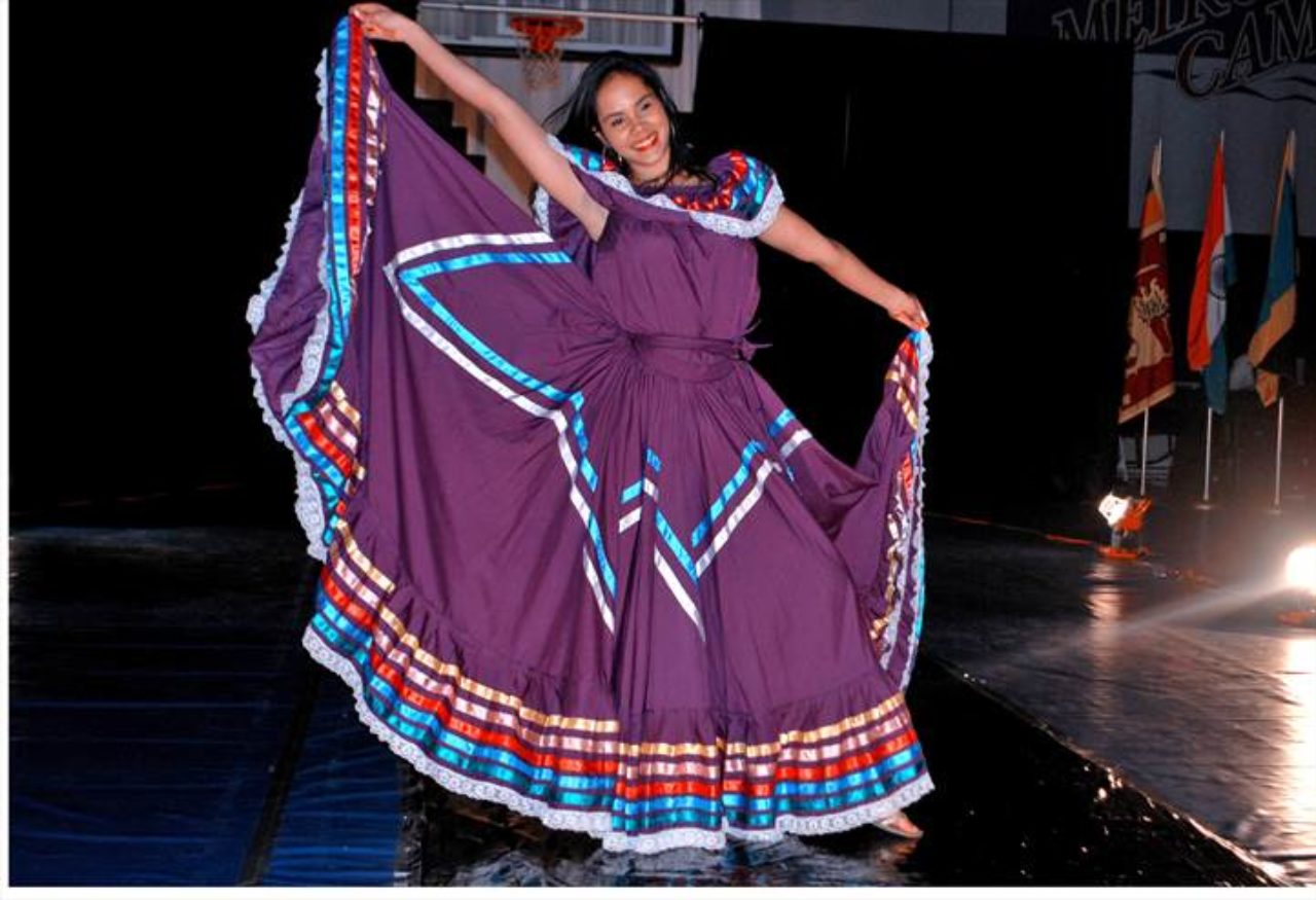 photo of an international student on stage wearing a cultural dress