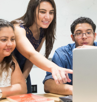 students working together behind a computer