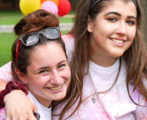 four female students hugging