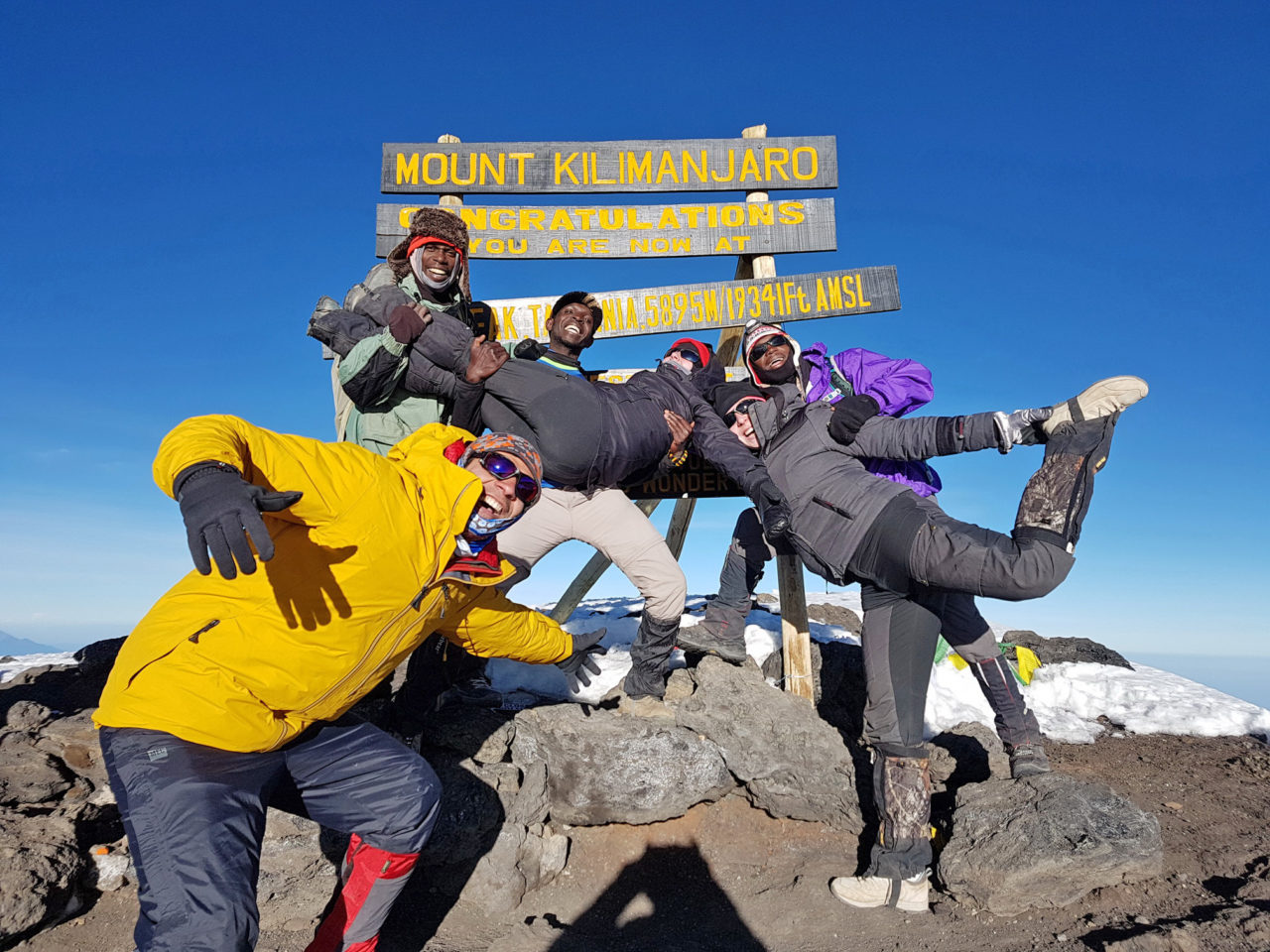 Foad Davani, BA’13, MAS’14 (Van), and his climbing guides and crew celebrate reaching the top of Mount Kilimanjaro