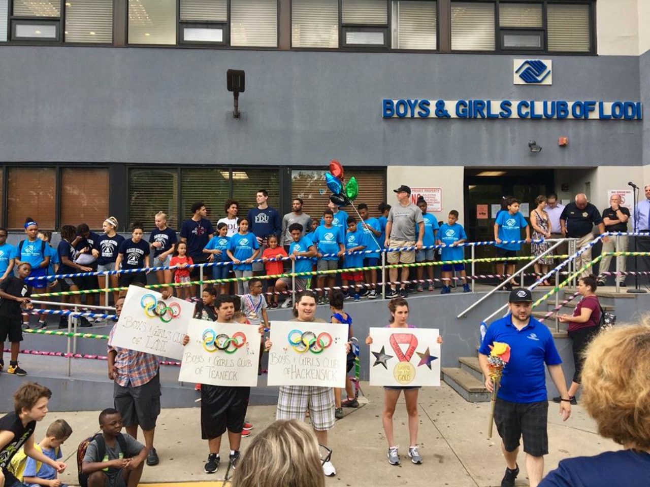 students holding "Boys and Girls Club" signs