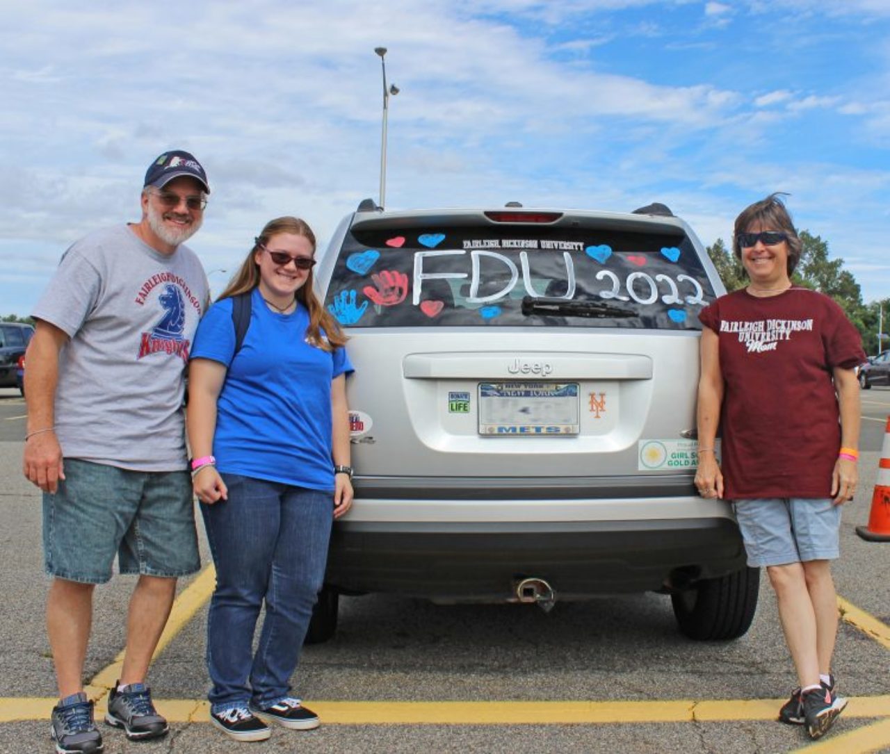 family in front of decorated car