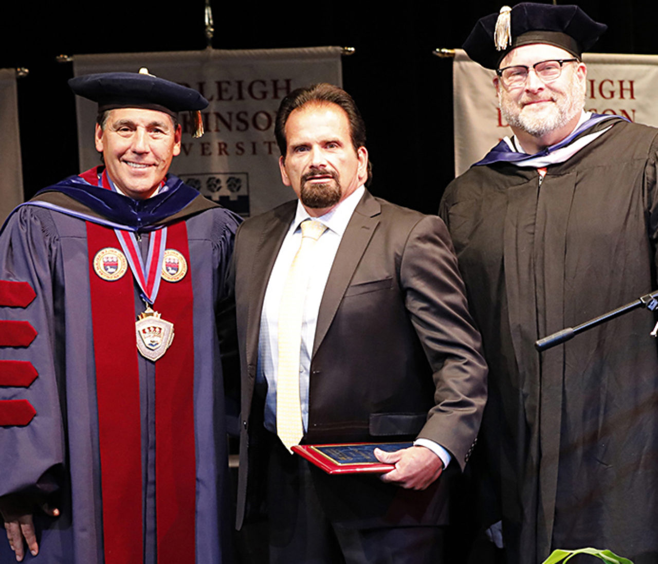 Michael Noe, flanked by University President Christopher Capuano and interim Metropolitan Campus Executive Craig Mourton, received the Pillar of FDU award