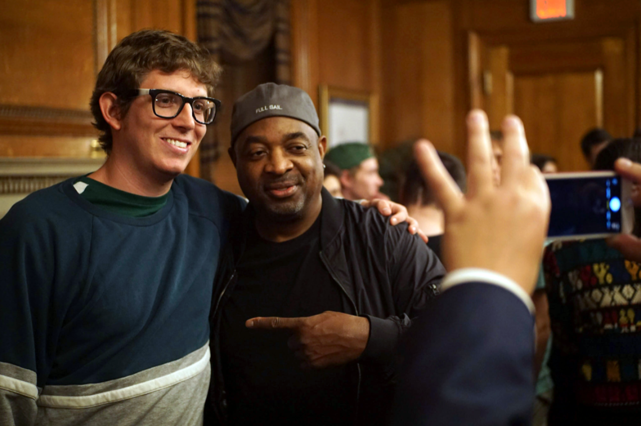 A student poses for a photo with Chuck D. (Photo by Ryan Silva)