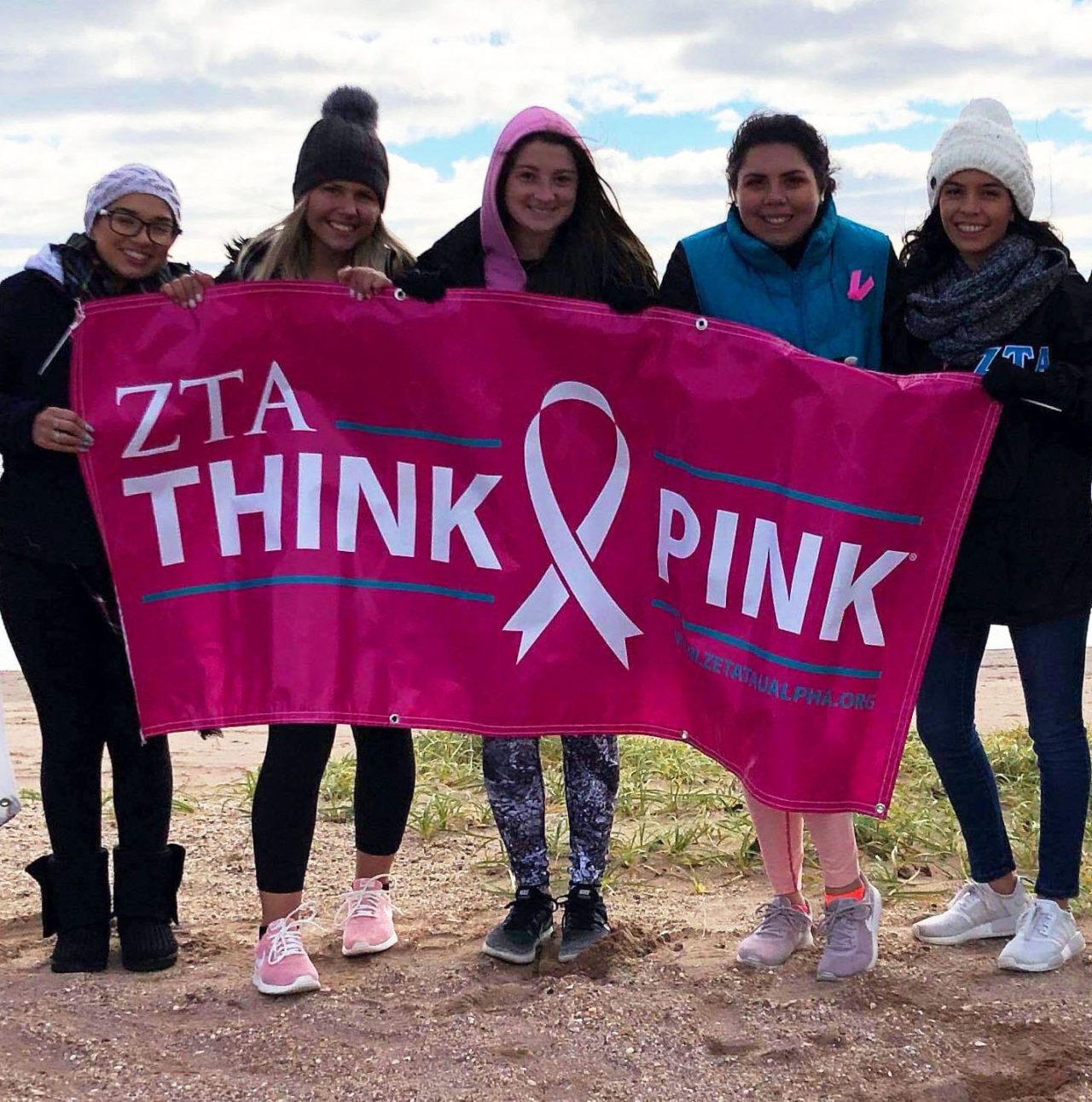 five girls with "Think Pink" sign