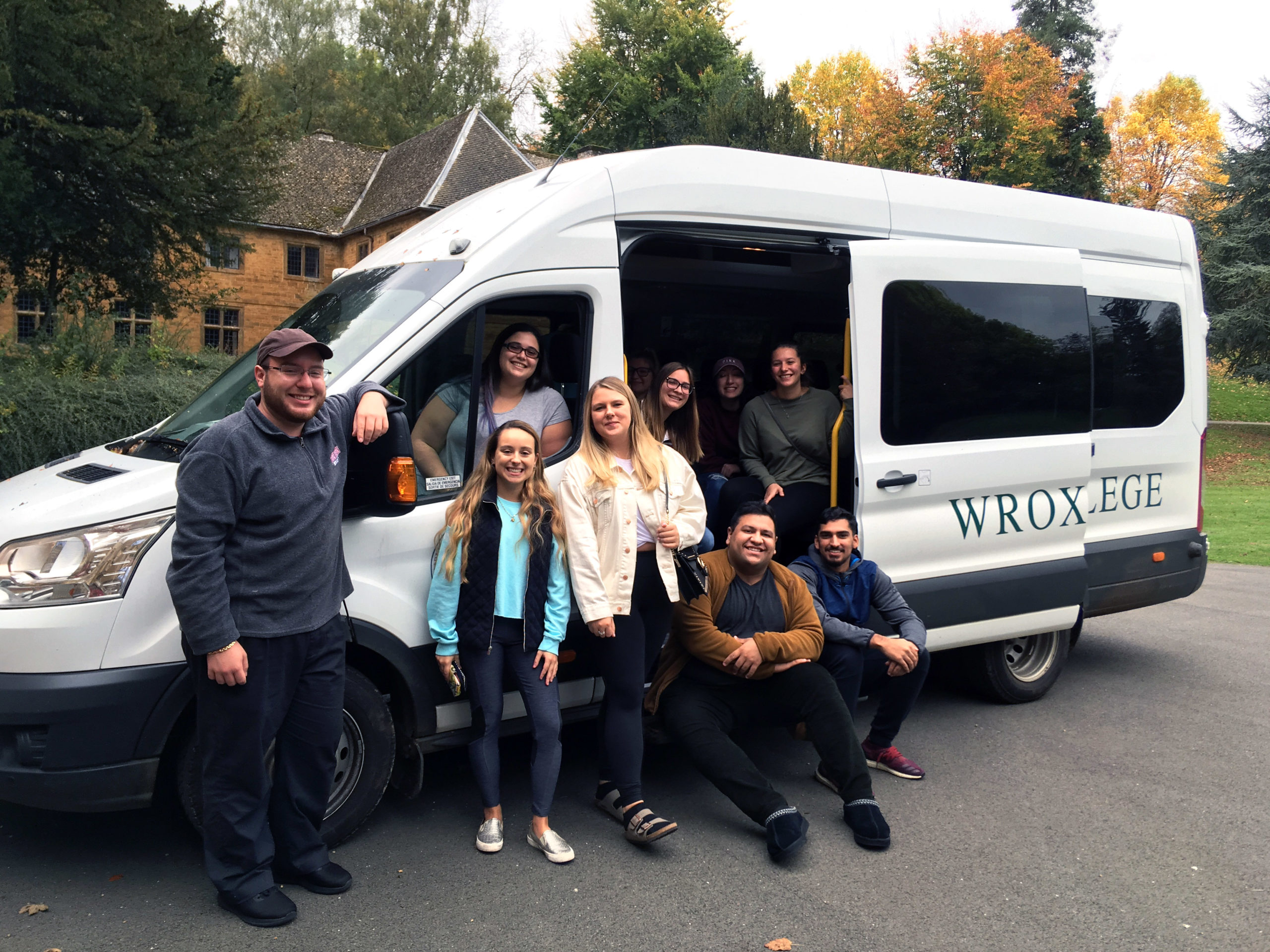 Students in a mini van that reads "Wroxton College."