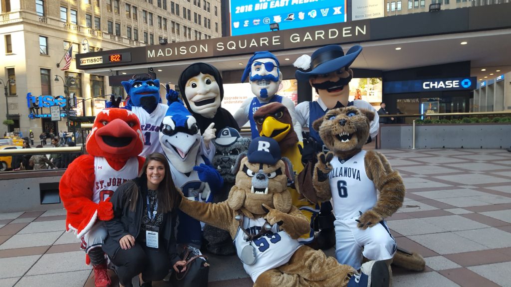 Alumna Cat Krawiec with mascots from the Big East Conference in front of Madison Square Garden