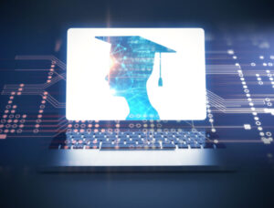 A graduate on a laptop computer screen wearing a graduation cap with a computer board background. 