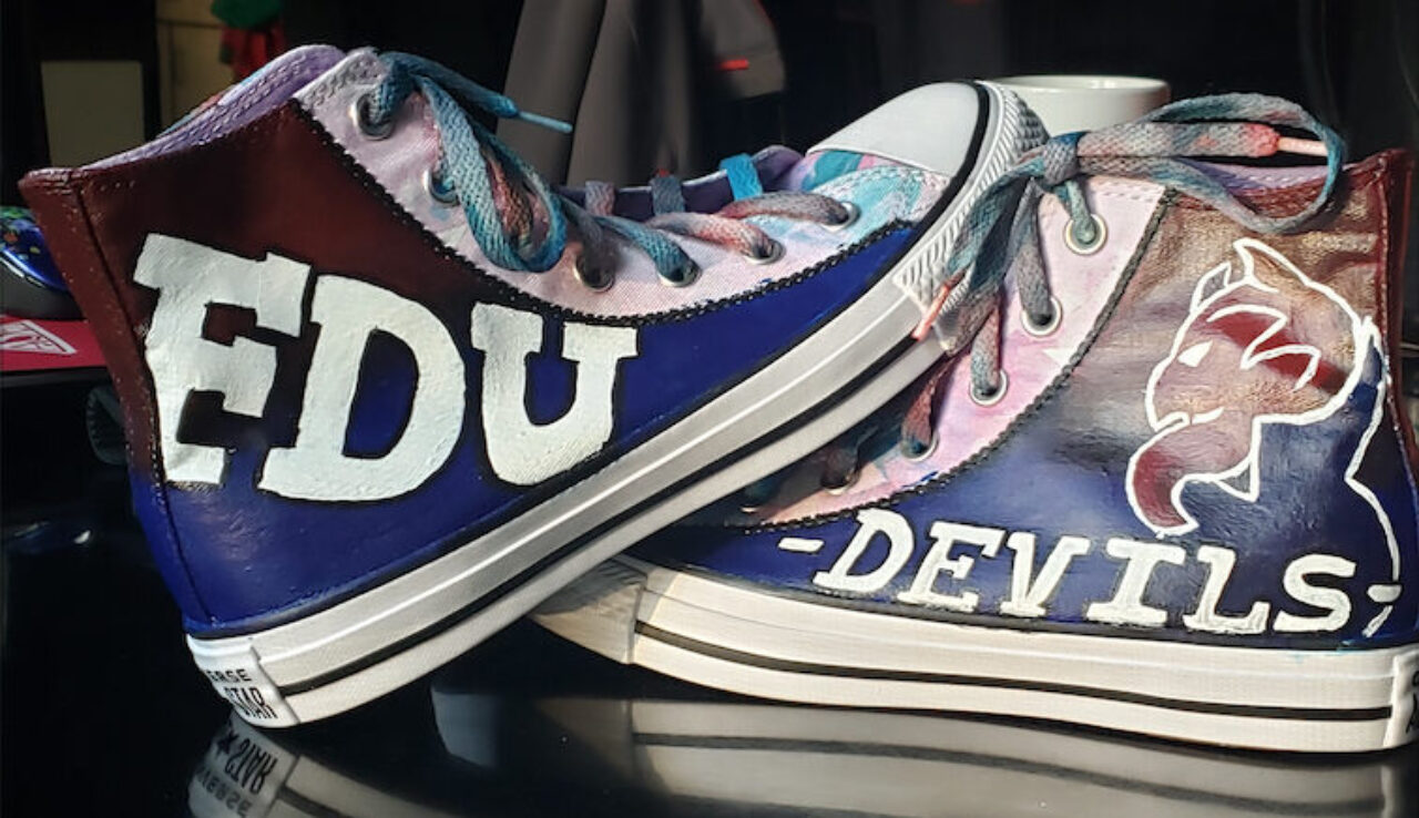 A pair of Converse painted with FDU and FDU Devils logo in the school colors