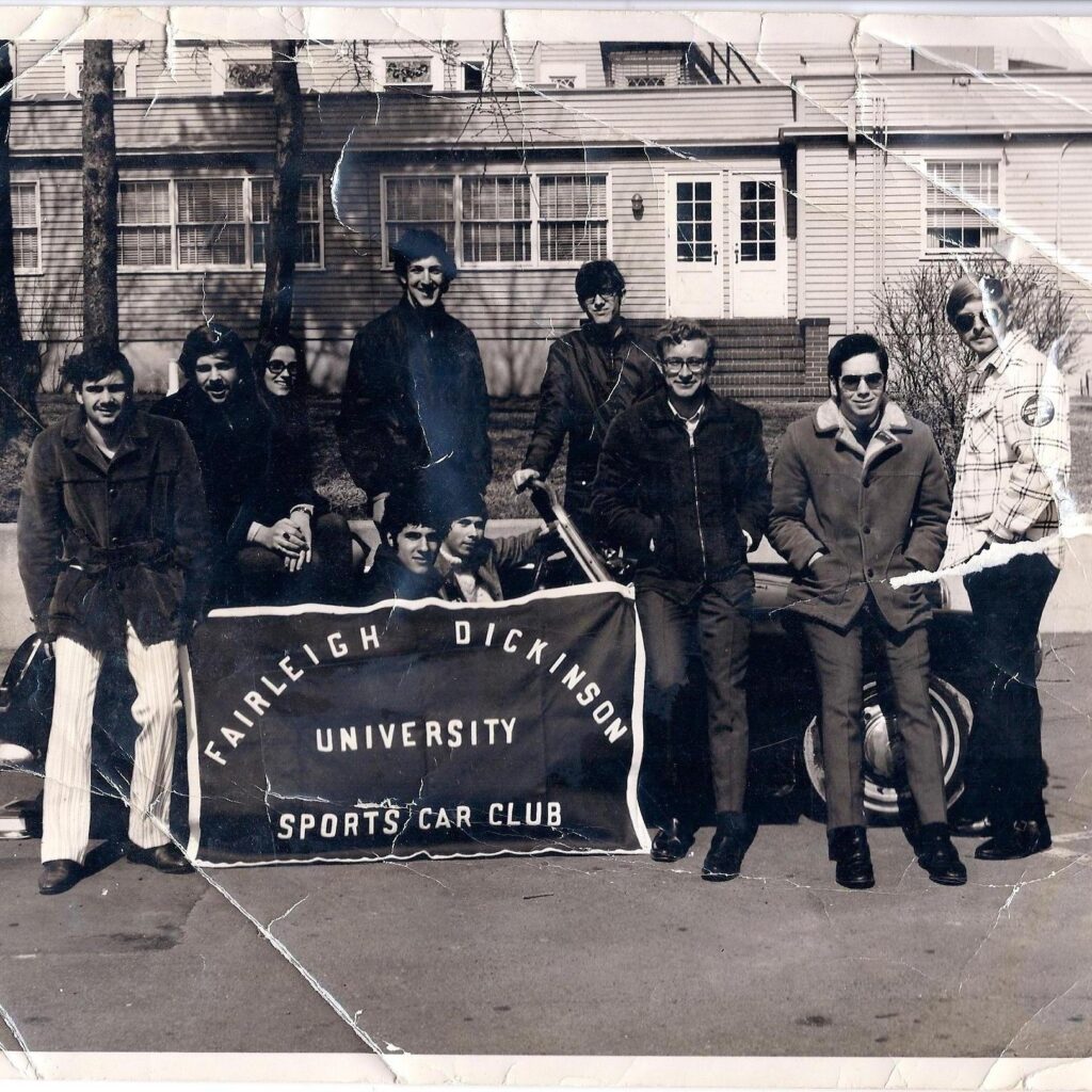 A photo of some of the members of the sports car club from the 60s. 