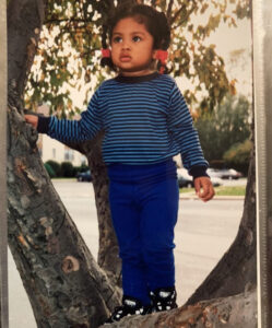 Tiffanie Arokiaswamy as a small child climbing in a tree. 