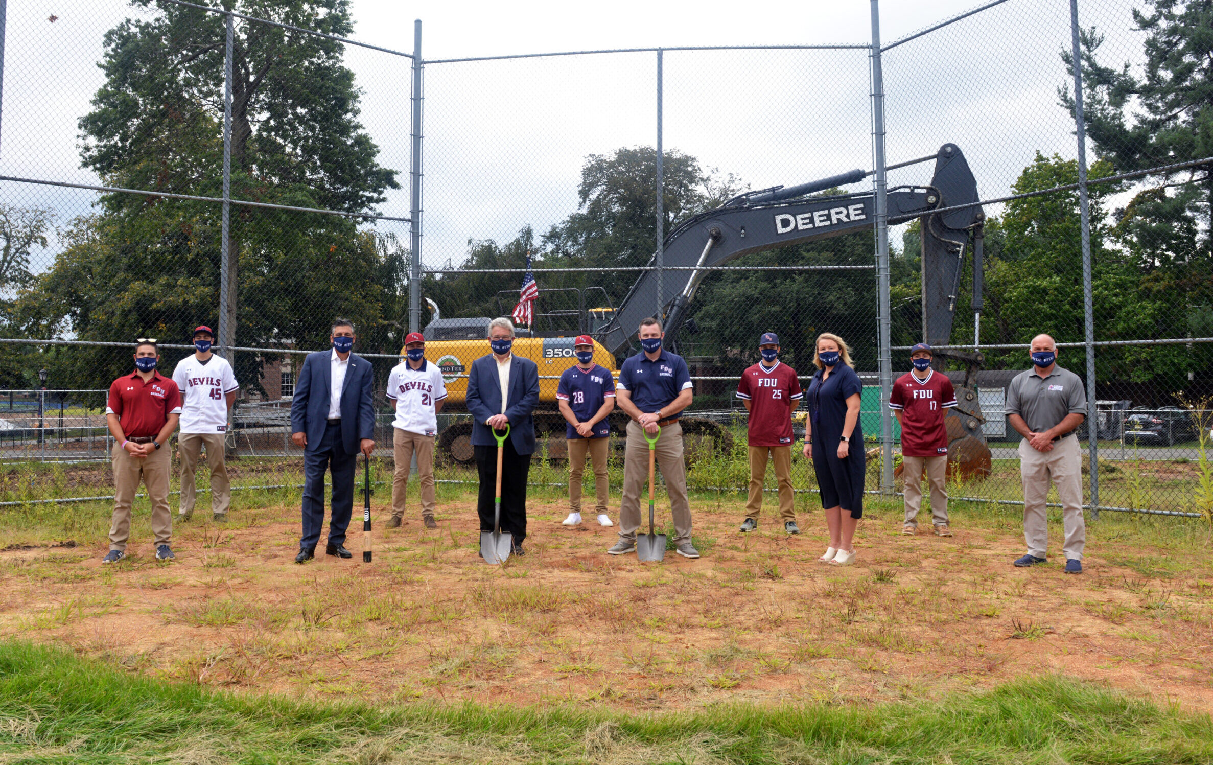 Members of the FDU Devils baseball team join University President Capuano, VP for Facilities & Auxiliary Services Dick Frick, head baseball coach Jamie Quinn, Director of Athletics Jenn Noon at the Naimoli Field groundbreaking at FDU's Florham Campus. Capuano holds a bat, Frick and Quinn hold shovels.