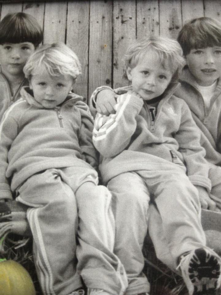 The four young Stewart brother pose for a photo in matching clothes. 