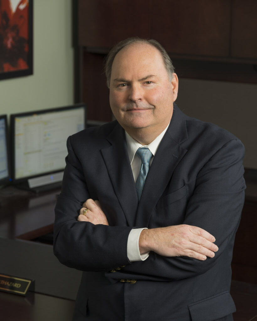 Portrait of a businessman, wearing a suit, in an office.