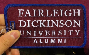 An alumni luggage tag in the FDU colors