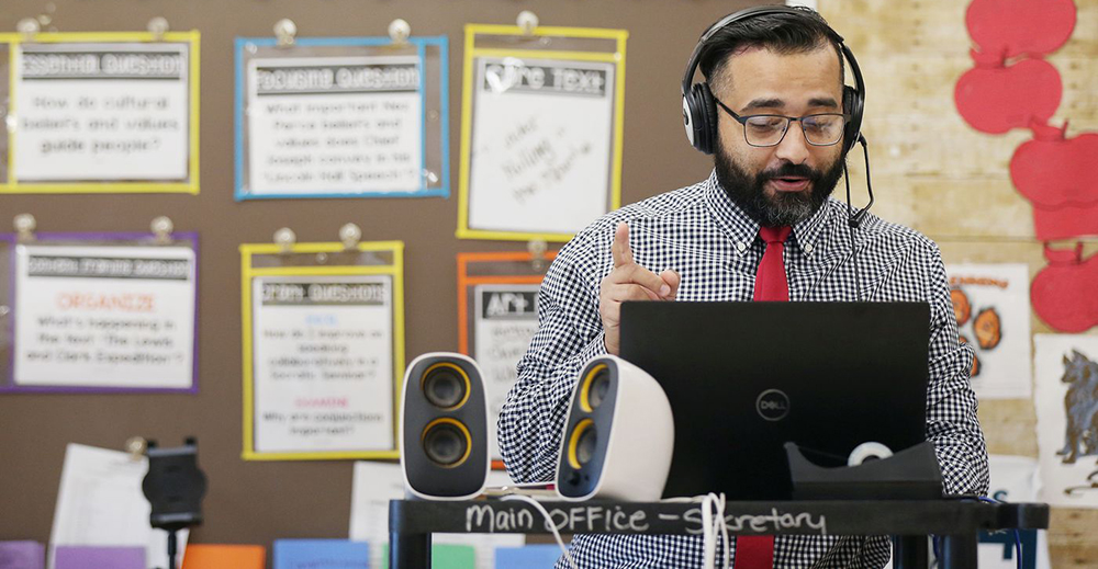 Photo of Angel Santiago behind a laptop