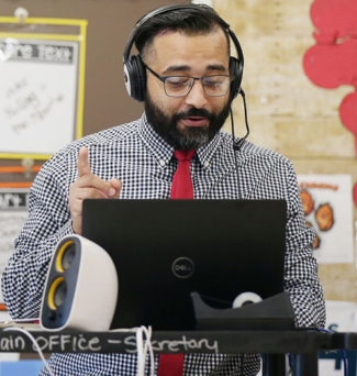 Angel Santiago in his classroom teaching virtually.