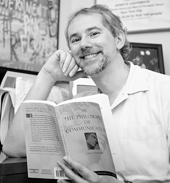 Portrait of a man reading at his desk.