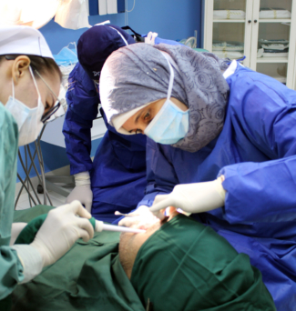 Heba Eldeeb practicing dentistry on a patient.