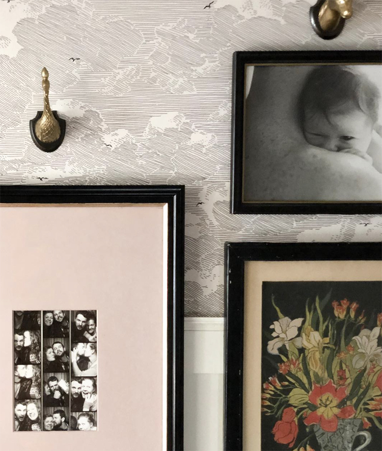 A photo wall with family pictures and flower art.