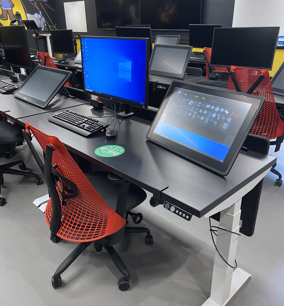 A workstation for a student animator, complete with two computer monitors, including a drawing tablet.