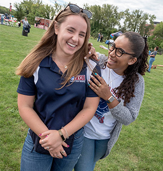 Two students smile