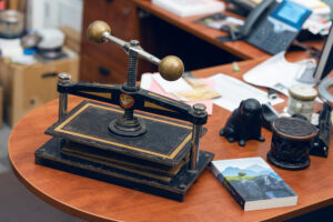 A bookbinding press atop a desk.