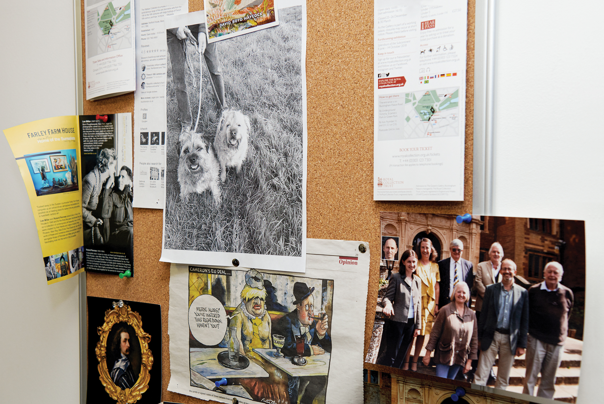 A bulletin board with a smattering old photos and newspaper clippings.