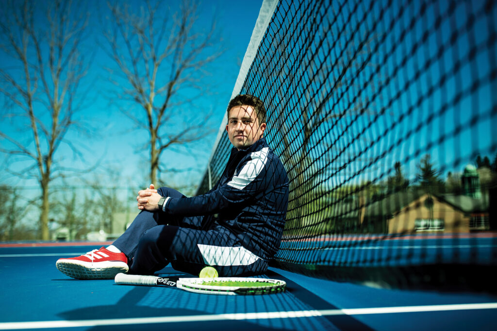 CJ Milano sitting on a tennis court