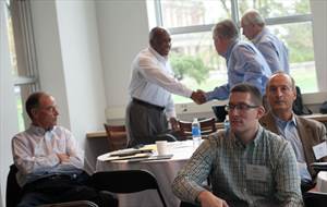 Instructor and students greeting each other with a firm handshake.