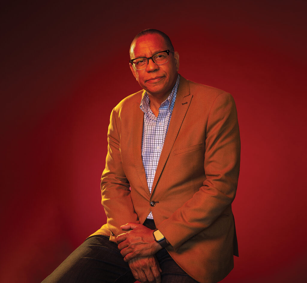 Portrait of a man wearing glasses, dressed in business casual attire.