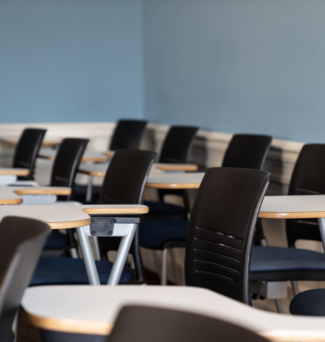 A classroom with empty desks and chairs.