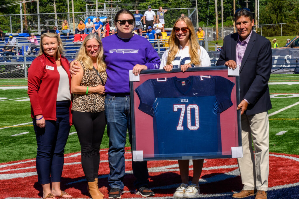 Family and friends of the late Daniel Bucci, BS'83 (Flor), accept his #70 jersey. (Photo: Brian Lewis)