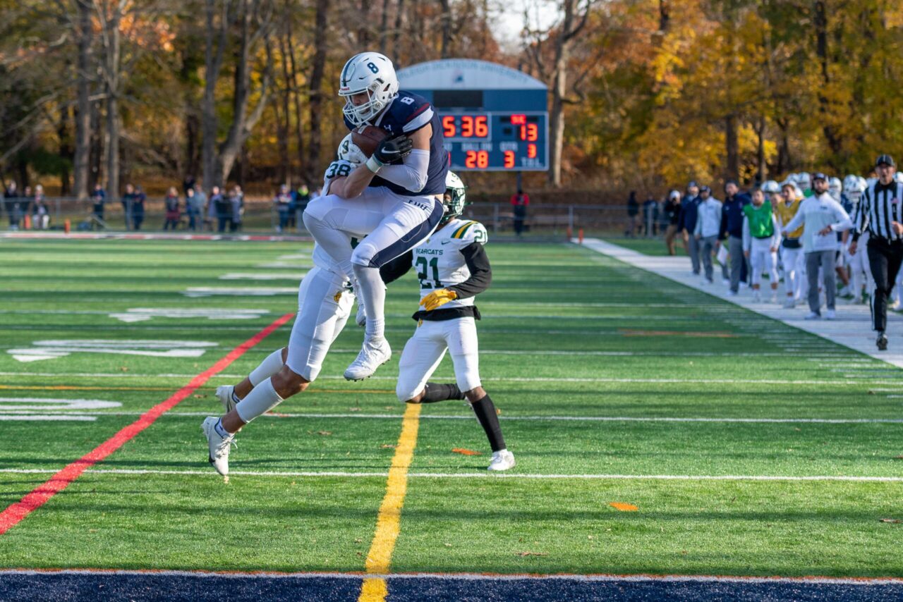 A football player goes in for a tackle.