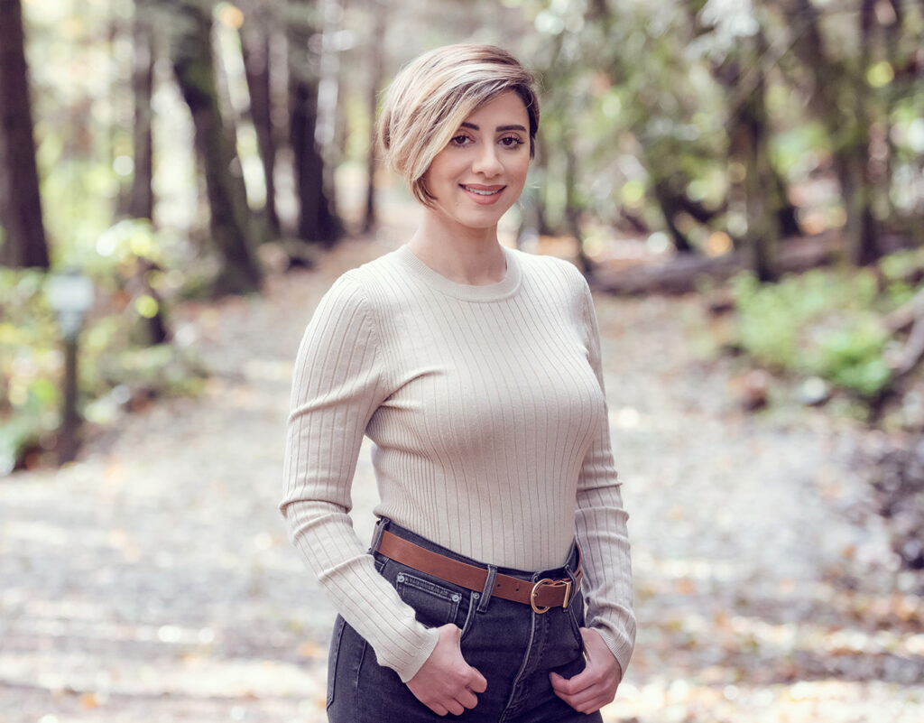 Portrait of a woman standing on a nature trail.