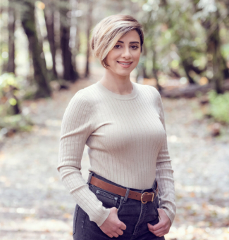 Portrait of a woman standing on a nature trail.