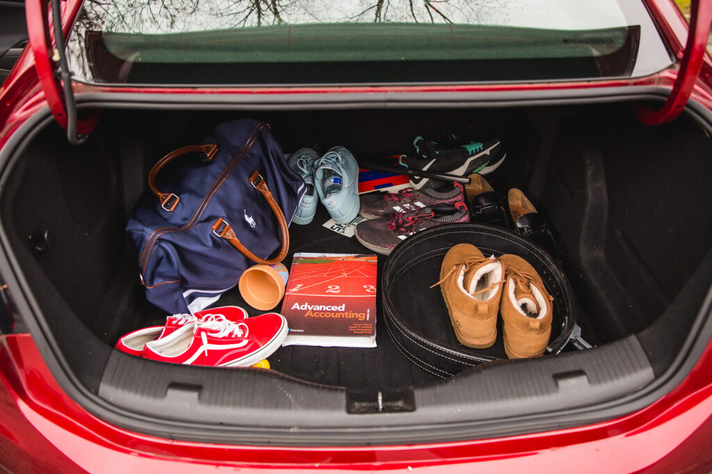 In the trunk of a car, a Polo bag, several pairs of shoes, an accounting textbook and more.