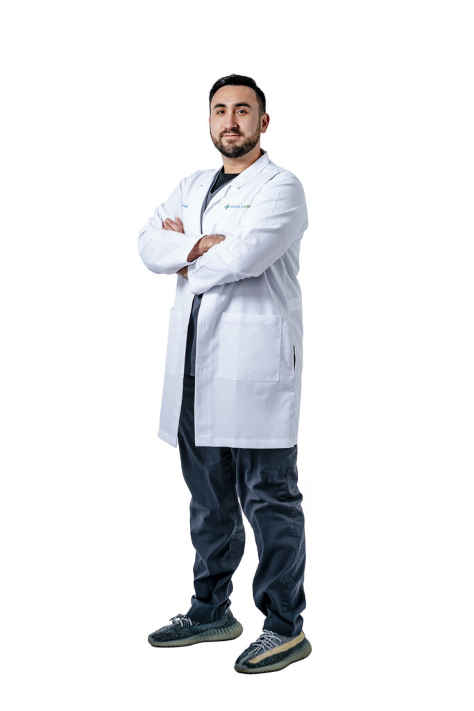 Portrait of a man wearing a white lab coat.