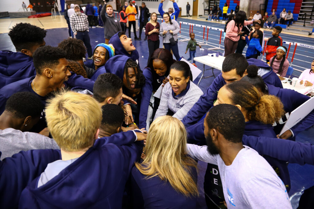 Sharlene Milwood-Lee rallies her athletes before their events at an indoor meet. (Photo: Larry Levanti)