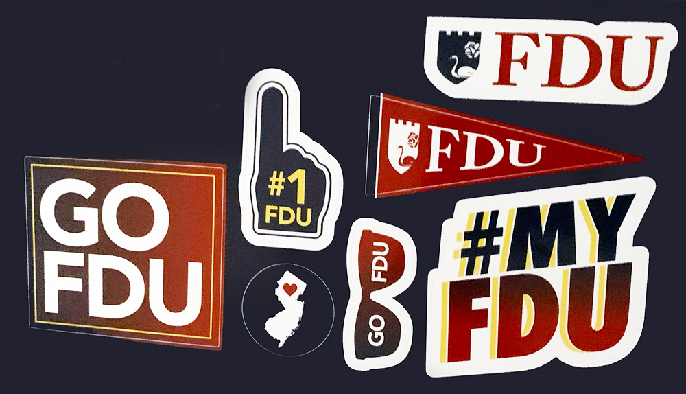 University pride stickers. Some say "go FDU" or "#myfdu."