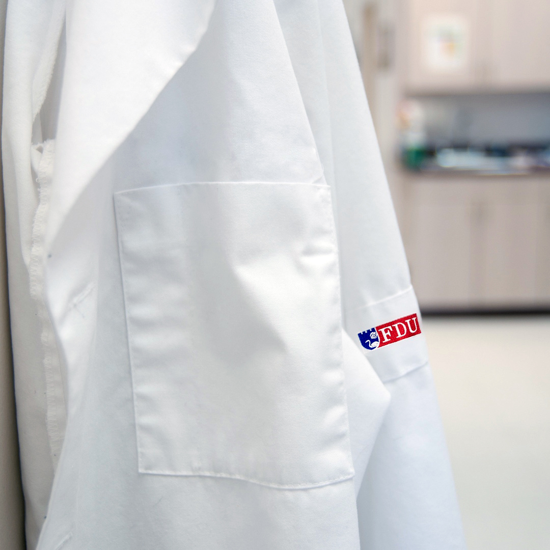 An FDU-branded white lab coat.