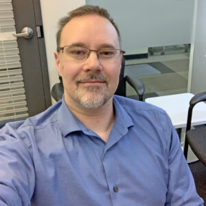 Portrait of a man sitting in an office.