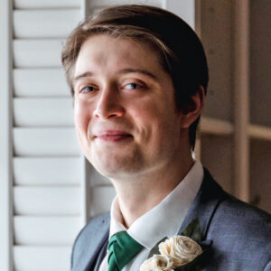 Portrait of a man in a suit with a boutonnière.