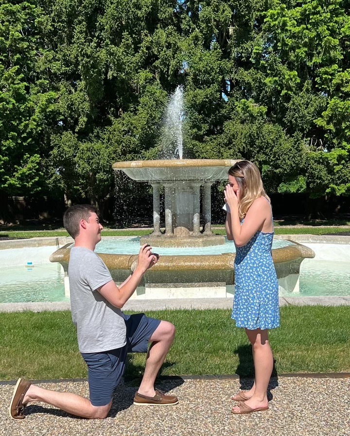 an engagement in front of the hennessy hall fountain