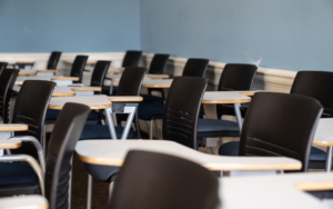 An empty classroom, full of desks.