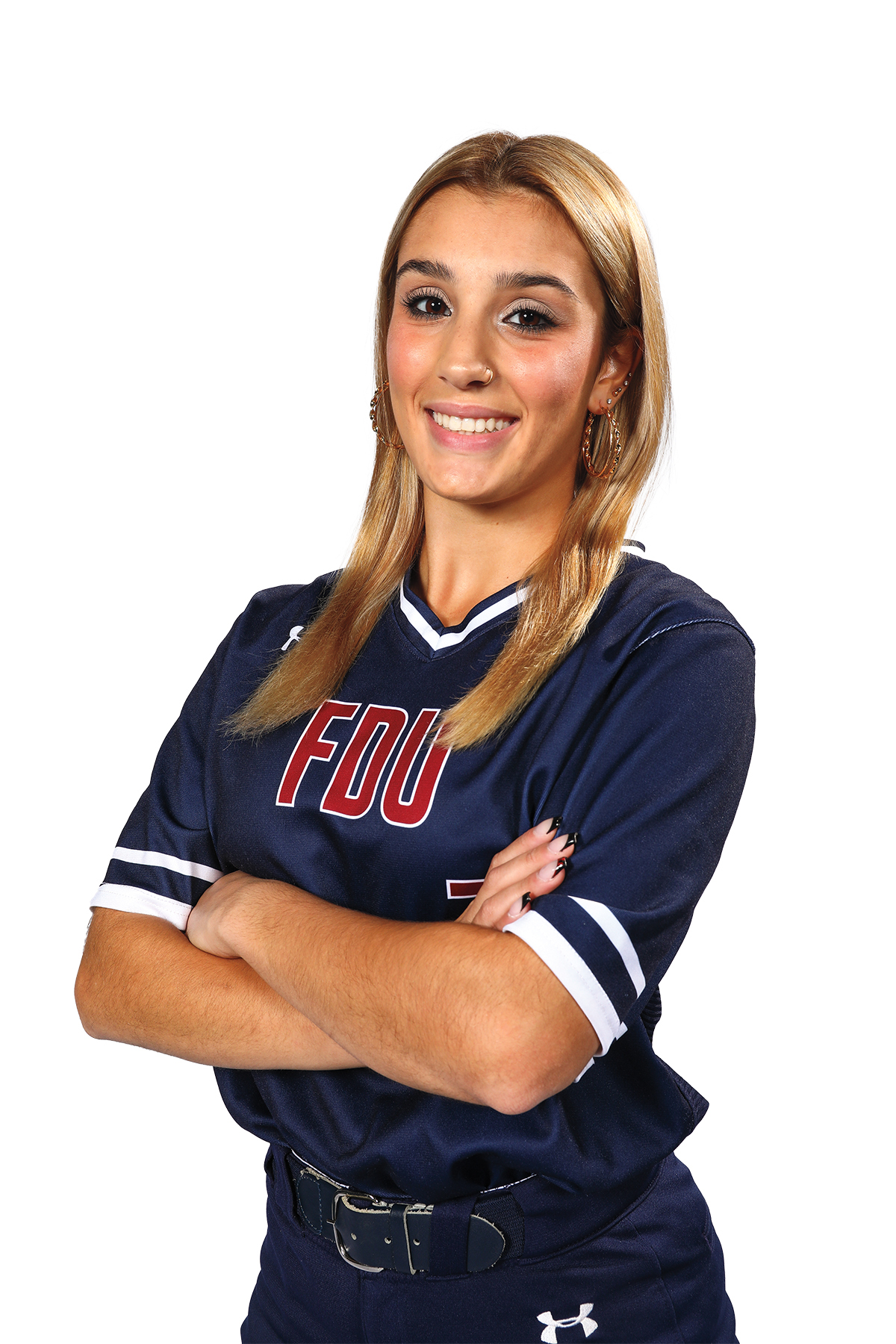 A white female poses with her arms crossed in a FDU Knights softball uniform.